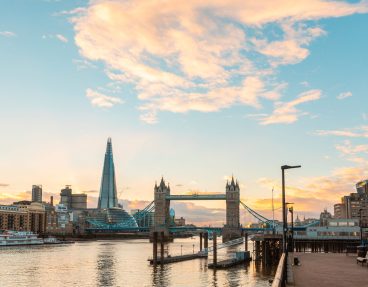 London view at sunset with Tower Bridge and modern buildings - Panoramic view of London with Thames river on foreground and famous landmarks on backgrounds